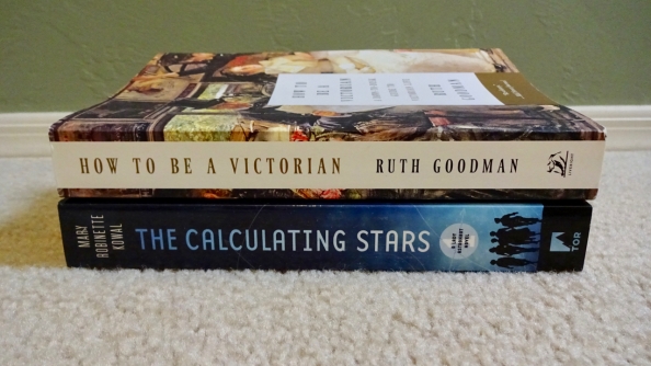 A stack of two books: "How to be a Victorian" by Ruth Goodman, and "The Calculating Stars" by Mary Robinette Kowal.